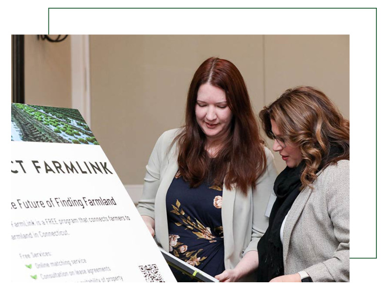 women farmers looking at document