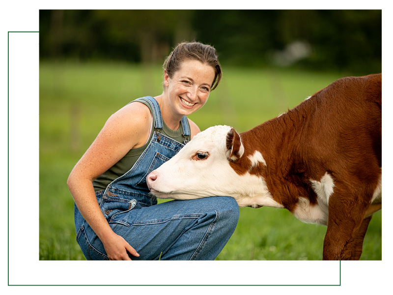 young woman farmer with cow